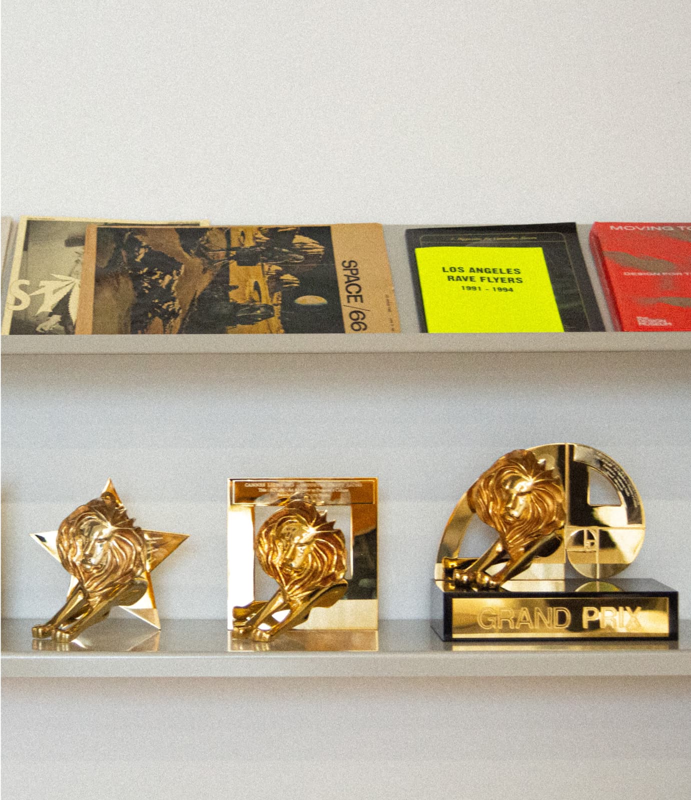 Various Magazines and Cannes Lions Awards of Antinomy Studio on a shelf at the Amsterdam office